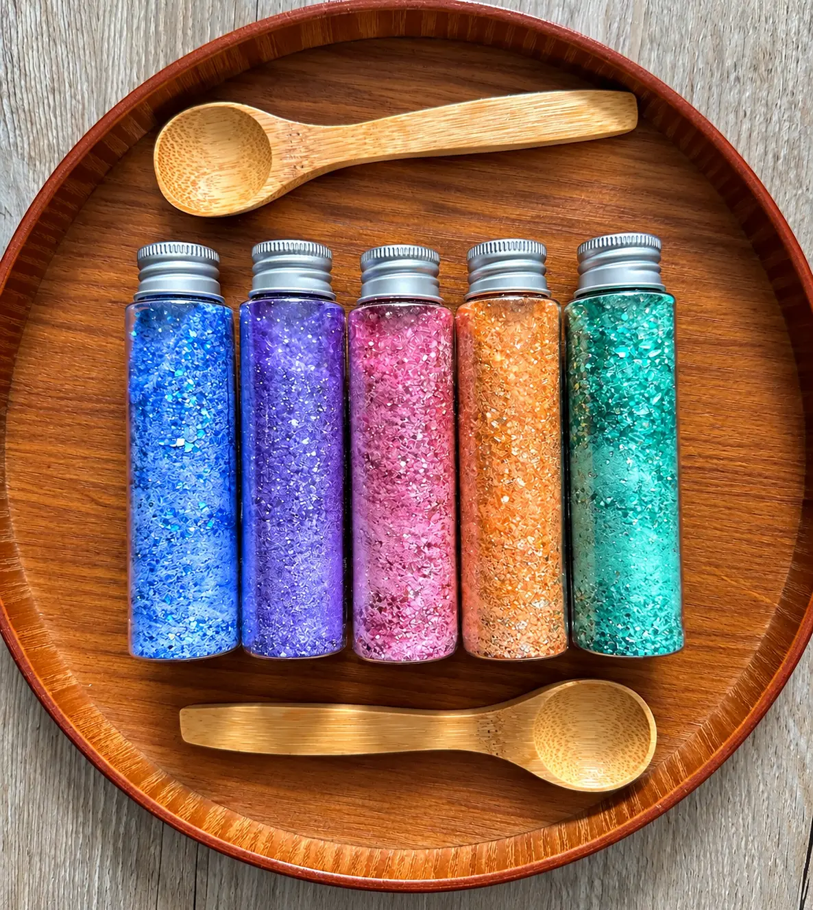 Five colourful Lykke Potion Lab tubes with a wooden spoon and pipette